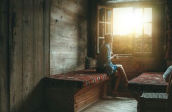 CBD for anxiety — peaceful person at window in soft morning light