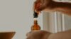 CBD dosage guide — hand holding amber dropper bottle in natural light