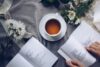 Warm bedside lamp and open book — evening wind-down routine for recovery