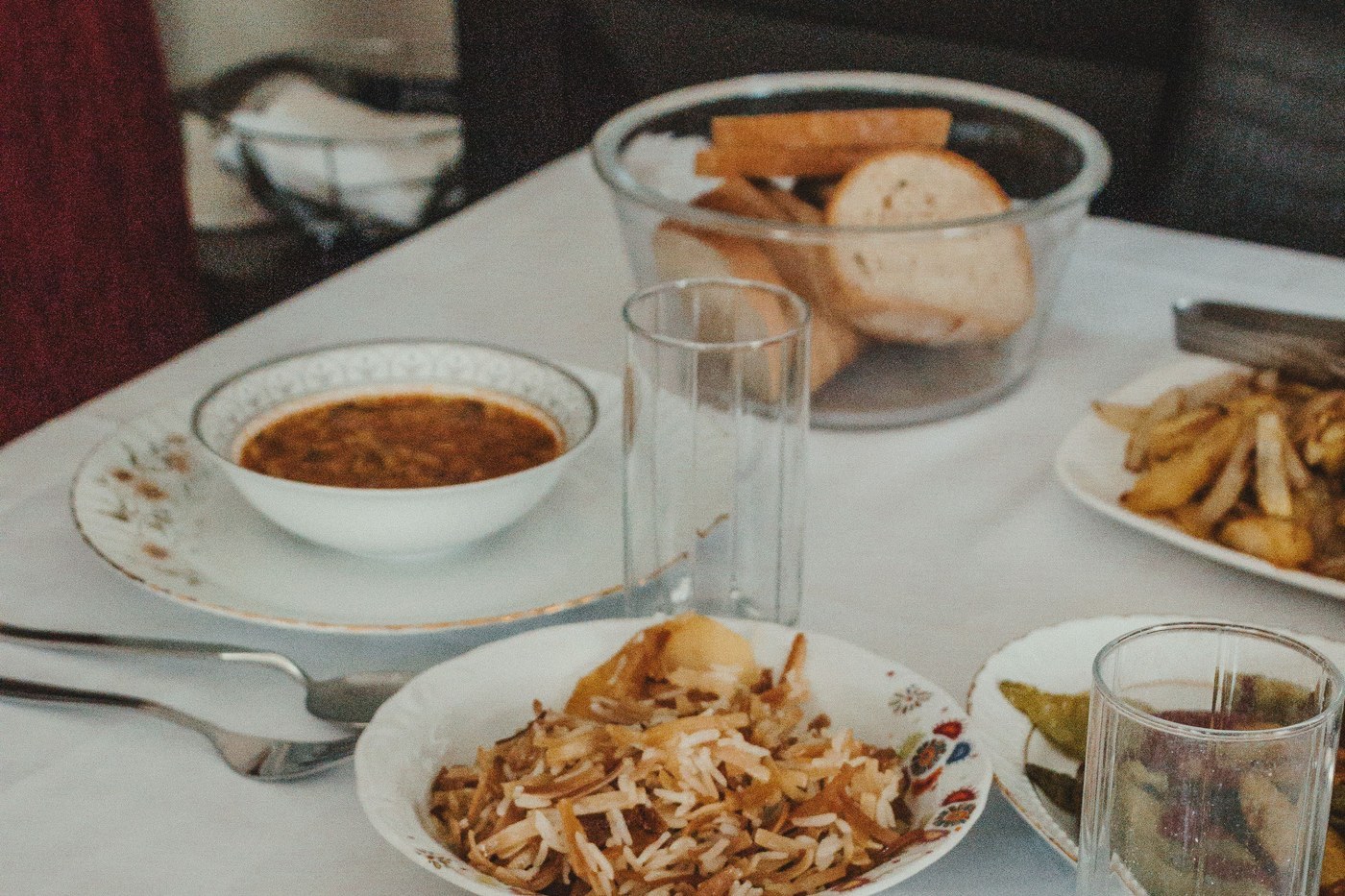 A laid table with soup, bread and water at an ordinary family meal
